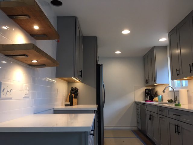 Modern kitchen with gray cabinets and built-in appliances.