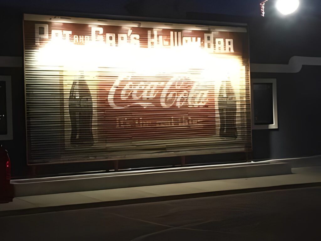 Vintage Coca-Cola advertisement at night